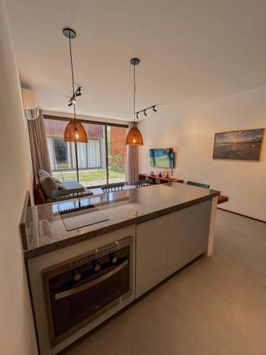 a kitchen with a large island in a room at Villa Naluri - Casa Yodo - Apartamento 1 quarto em Japaratinga in Japaratinga