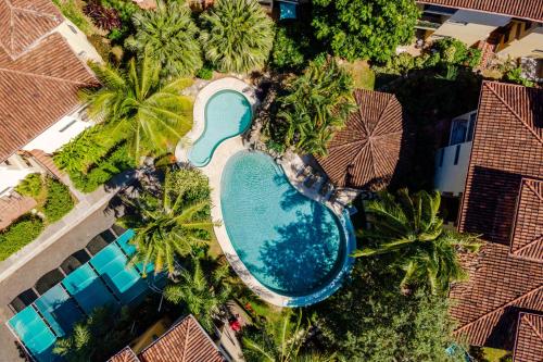 an overhead view of a pool with palm trees and houses at Luxury 2BR Escape near Tamarindo in Tamarindo