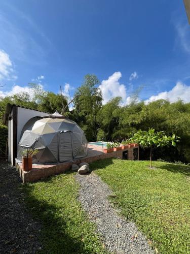 a large tent on the grass next to a house at Casa Campestre in Pereira