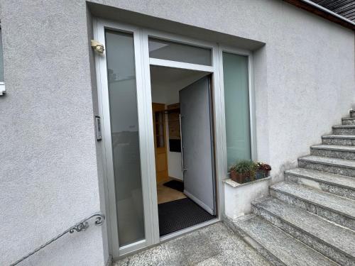 a glass door of a building with a staircase at Mondseepanorama in Tiefgraben
