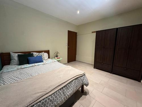 a bedroom with a large bed and a cabinet at Seaview Oasis in Gated Community and Walk to Beaches in Willemstad