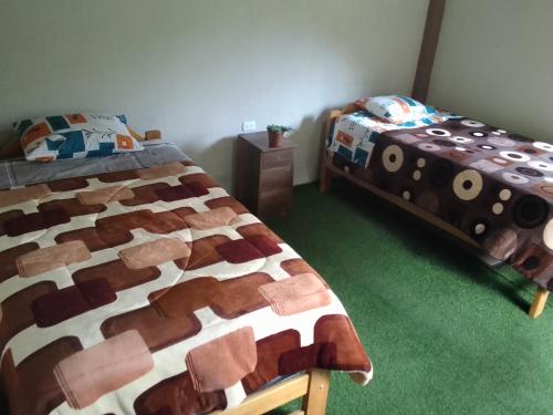 Postel nebo postele na pokoji v ubytování Rumi Wasi Hostel