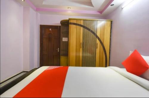 a bedroom with a bed and a wooden door at Hotel Pinnacle Tower - Near Airport in kolkata