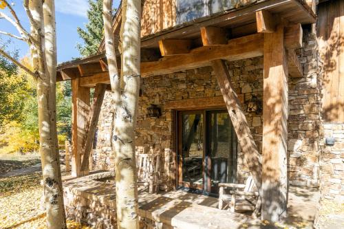 a stone house with a wrap around porch at Mountain House by Exceptional Stays in Telluride