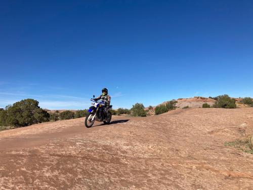 a person riding a motorcycle on a dirt road at Moab Views, Pool, Hot Tub, Natl Parks in Moab