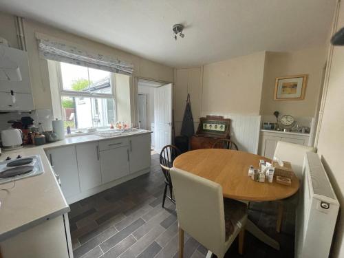 a kitchen with a wooden table and a dining room at Market Hall in Kington