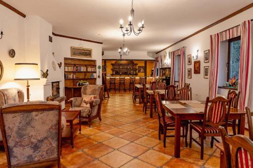 a dining room with tables and chairs and a library at Pod Kogutem in Cierzpięty