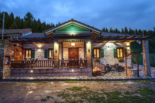a house with a porch with lights on it at Archontiko Theofanous 1915 in Tríkala
