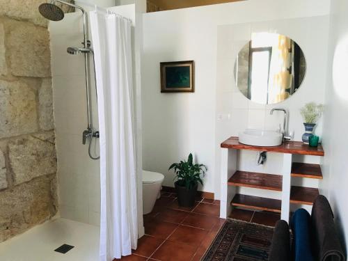 a bathroom with a shower with a toilet and a sink at Casa Bella para peregrinos- Charm House for pilgrims in A Guarda