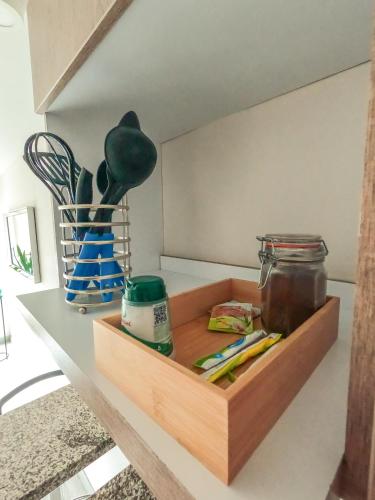 a wooden box with some utensils on a table at Santorini Apartamentos Amoblados in Pereira