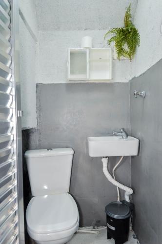 a bathroom with a toilet and a sink at Casa com Garagem in Guarulhos