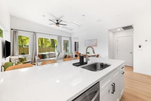 a kitchen with a sink and a living room at New-Dog Friendly,Hot Tub, Fire-pit, 1 mile to DTWN in St. Augustine