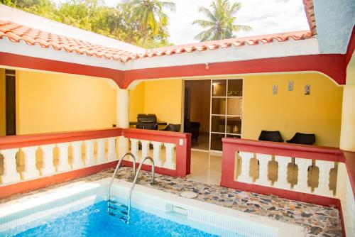 a pool in the middle of a house at Boom Ranch in Las Galeras