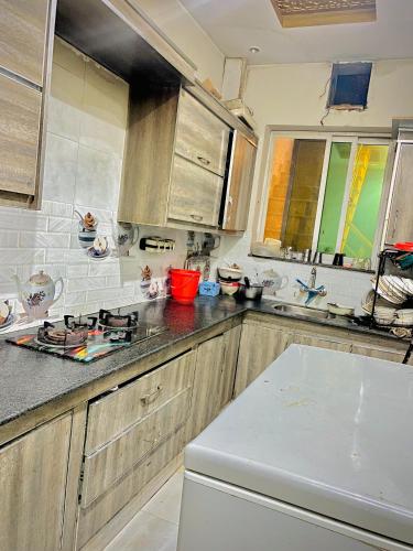 a kitchen with a sink and a stove top oven at Doveinn Hotel R1 in Lahore