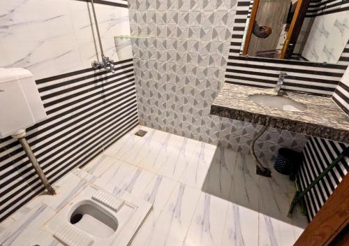 a bathroom with a toilet and a sink at Doveinn Hotel R1 in Lahore
