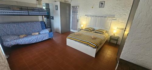 una camera da letto con un letto e un letto a castello gmaxwell gmaxwell gmaxwell gmaxwell di Villa pied dans l eau a Cala dʼOro