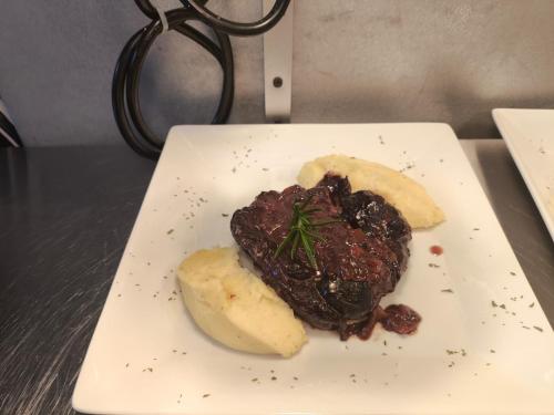 a plate of food with meat and potatoes on a table at Hotel Amigo Nicaragua in Nindirí