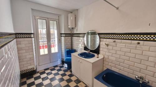 a bathroom with a blue sink and a mirror at Casa Menta in Bañeres de Mariola