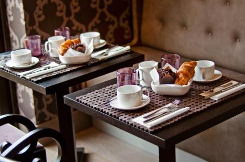 a table with pastries and croissants on it at The Hide London in Hendon