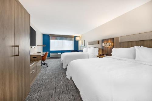 a hotel room with two beds and a desk at Holiday Inn Express & Suites Nashville West End - Univ Area by IHG in Nashville
