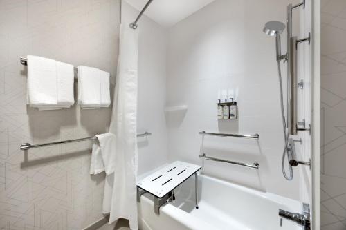 a white bathroom with a shower and a sink at Holiday Inn Express & Suites Nashville West End - Univ Area by IHG in Nashville