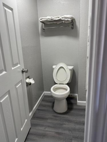 a bathroom with a white toilet in a room at American Inn Port O'Connor in Port O'Connor