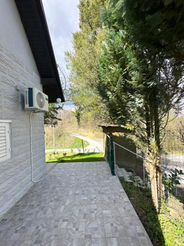 a view of a driveway with a fence and a tree at Zagorje rest house in Matenci
