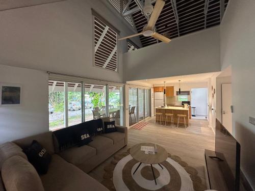 a living room with a couch and a table at Moorea Sunset Beach in Haapiti