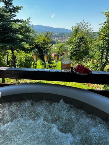 a table with drinks and wine glasses on a balcony at Zagorje rest house in Matenci