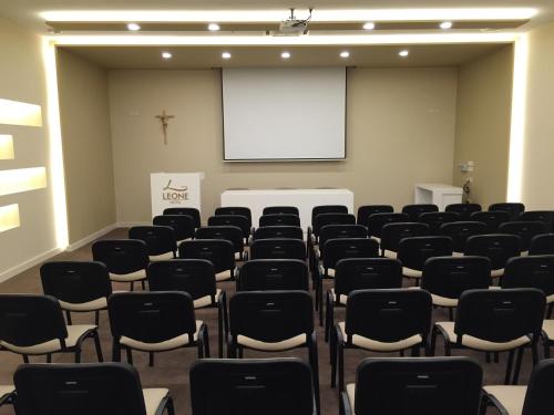 a lecture room with chairs and a white screen at Hotel Leone in Međugorje