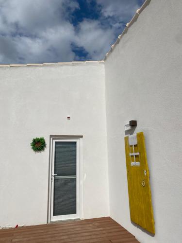 a white building with a door and a window at Portugals Infinity Eco Suite Resort in Tavira