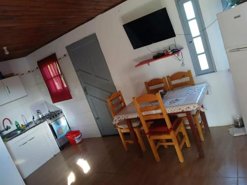 a kitchen with a table and chairs in a room at Casa alquiler Barra de Chuy Uruguay in Barra del Chuy