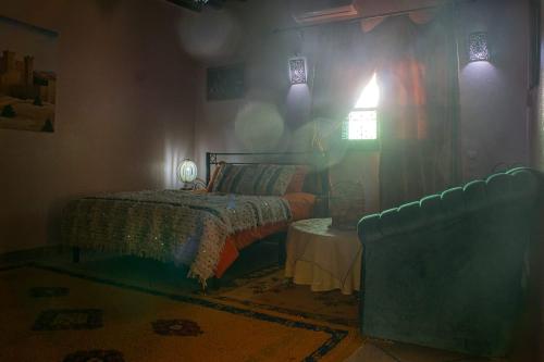a bedroom with a bed and a couch at Lamtounipalace in Ouarzazate