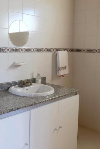 a white bathroom with a sink and a mirror at Finca campestre de 2 pisos en Guarne in Guarne
