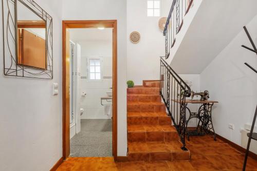 a hallway with a stairway with a mirror and a stairwayngth at Sea View Villa by Homie in Santa Cruz