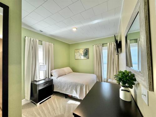 a bedroom with a bed and a table in it at Home in Downtown Concord in Concord