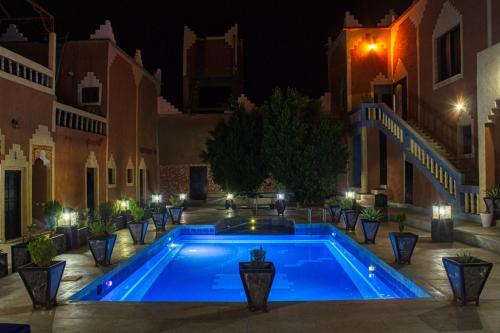 a swimming pool in a courtyard at night at Lamtounipalace in Ouarzazate