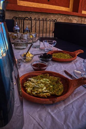 a table with a plate of food on a table at Lamtounipalace in Ouarzazate