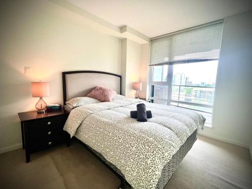 a bedroom with a bed and a large window at Fabulous and convenient 2B2B close to Richmond center in Richmond