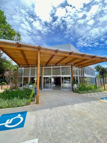 a building with a wooden pergola in front of it at Pipa Privilege Ocean in Pipa