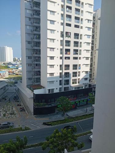 a large white building with a parking lot in front of it at Maldives City 1 in Male City