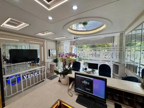 a room with a desk with a computer on it at Minh Ngoc Hotel in Ho Chi Minh City