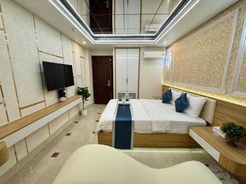 a bedroom with a bed and a flat screen tv at Minh Ngoc Hotel in Ho Chi Minh City