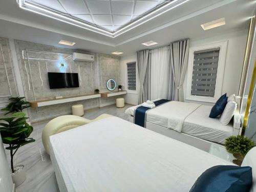 a hotel room with two beds and a tv at Minh Ngoc Hotel in Ho Chi Minh City
