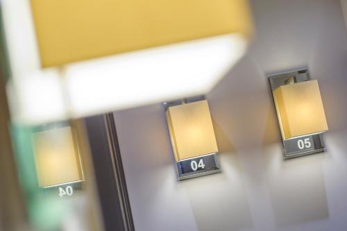 a pair of lights on a wall in a room at The Hide London in Hendon