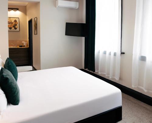 Ένα ή περισσότερα κρεβάτια σε δωμάτιο στο City Budget Hotel
