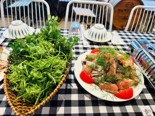 two plates of food on a checkered table at Giăng's House Farmstay & Glamping in Bao Loc