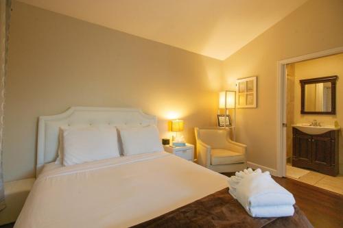 a bedroom with a large white bed and a sink at Sonoma Getaway for Two - Great Location in Sonoma
