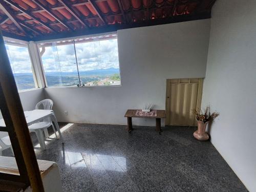 an empty room with a table and a window at Hotel Montanhas de Minas in Diamantina