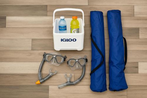 a pair of glasses and a bag on a wooden floor at Sea Esta Studio I - Ideal for Couples! in Turtle Cove